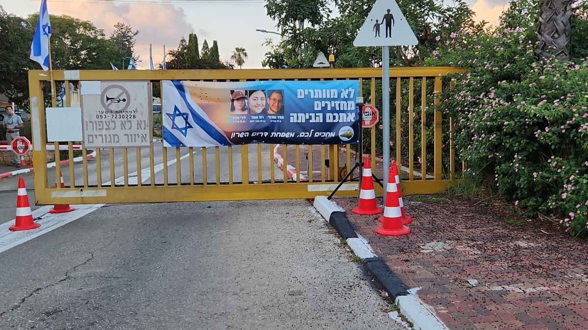 תמונה של כרזה למען שחרור החטופים תלויה בכניסות ליישובי המועצה השונים